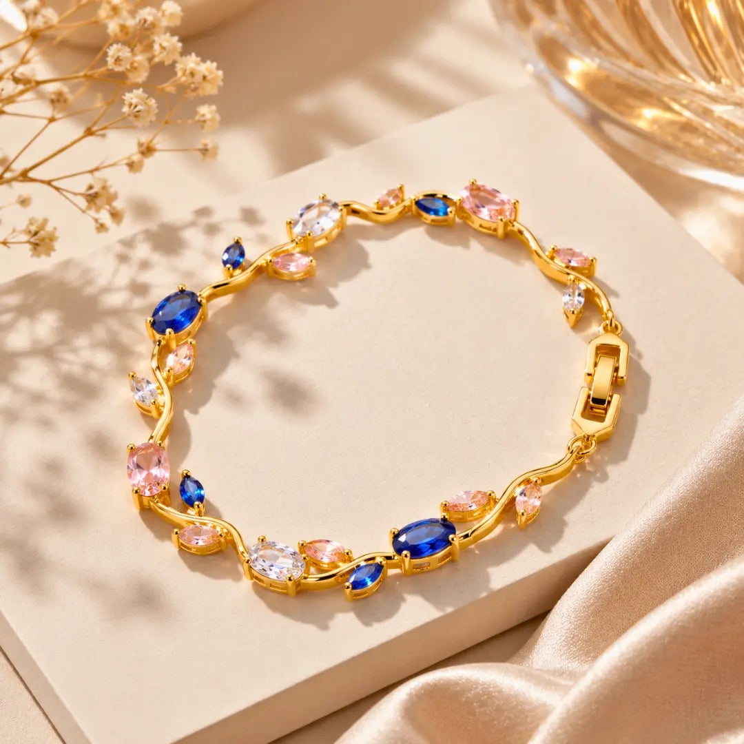 Gold bracelet with colorful gemstones on a beige surface