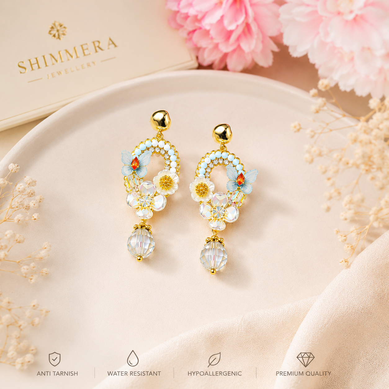 Decorative earrings on a white plate with pink flowers and Shimmera branding.