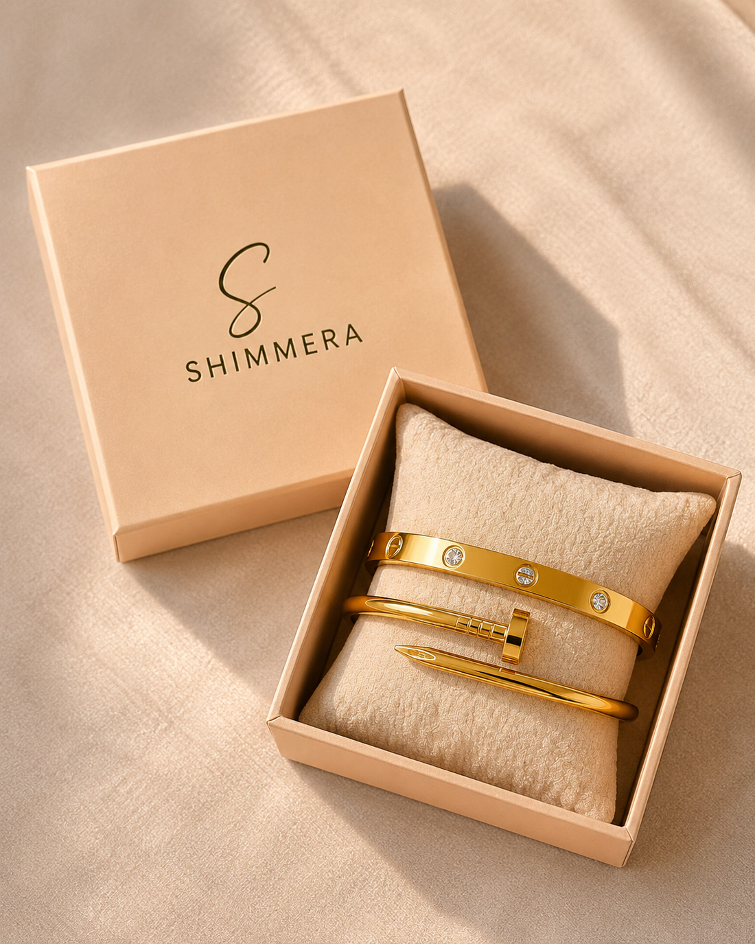 Gold jewelry set in a Shimmera box on a beige fabric background